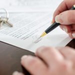 Woman signing a real estate contract