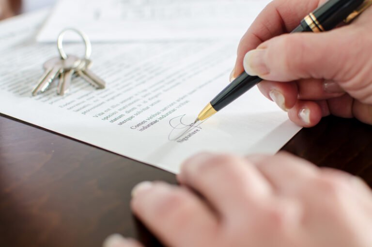 Woman signing a real estate contract